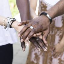 close-up-interracial-people-holding-hands-min close-up-interracial-people-holding-hands-min